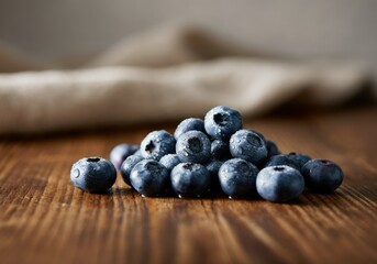 Fresh blueberries piled on a wooden surface, showcasing their vibrant color