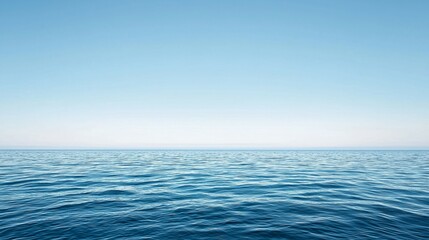 Naklejka premium Calm Ocean Waves Under Clear Blue Sky with Serenity and Peace