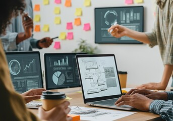 Team collaborating on data analysis with laptops and charts in a modern workspace