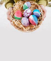 Colorful Easter eggs in basket. Kids hunt for eggs outdoors.