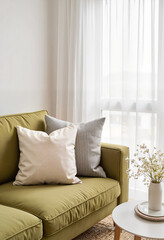 Serene minimalist living room with olive-green sofa, cozy ambiance