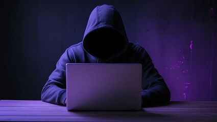 Young hacker hacking a network system with a laptop computer, danger for cyber security and antivirus commercial purpose. With purple light