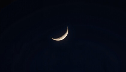 Crescent moon glowing in dark sky, cosmic serenity