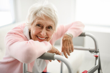 Beautiful senior woman in the living room with walk chair