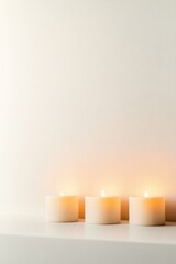 Softly glowing candles create serene atmosphere against minimali