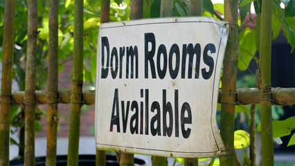 Closeup of dorm rooms available sign at hostel backpacker accommodation
