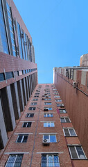 View of a multi-story brick building, viewed from bottom to top