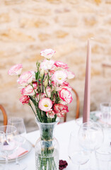 Beautiful bouquet with Eustoma flowers on table in bedroom. Space for text
