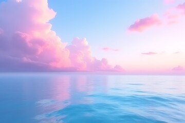 Fototapeta premium Pastel pink clouds and a serene blue ocean meet at the horizon.