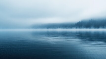 Fototapeta premium Misty fog blurring the outline of a lake, with subtle light reflections and a peaceful, serene vibe.
