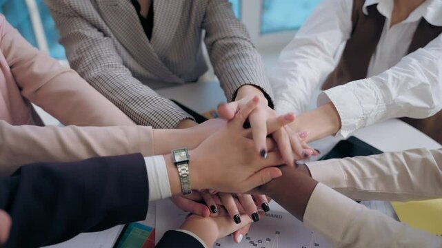 Top view happy smiling multiethnic women females diversity team girls group coworkers businesswomen stack hands gesture put palms team friendship together unity partnership support success in office
