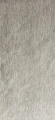 A close-up of a neutral gray textile texture, showcasing a subtle woven design, ideal for backgrounds or graphic designs.