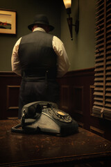 Portrait of detective and old phone in  vintage office. Picture on the wall is my picture.