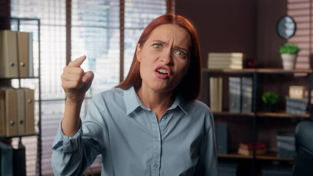 Portrait Caucasian girl angry furious rage mad aggressive business woman female worker businesswoman employer boss in office looking at camera yelling conflict scold argument anger talking screaming