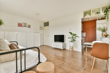 Bright and airy room featuring minimalist decor, wooden flooring, and tasteful furnishings creating a cozy atmosphere for relaxation and living.