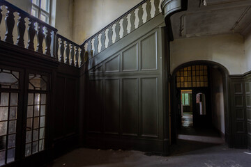 old historic ornamental staircase in abandoned building. carpentry work, balustrade on stairs,...