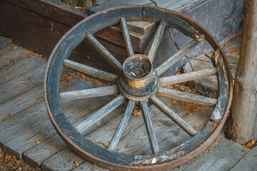 a very old, historic, antique horse cart wheel like from a western movie