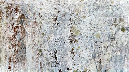 A close-up of a textured surface with weathered features and stains, showcasing natural patterns of aging and wear that contribute to the rugged aesthetic.