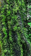 Vibrant green tinsel garland perfect for festive holiday decorations adding a touch of elegance