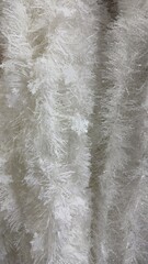 Elegant white tinsel garland creating a festive winter holiday atmosphere perfect for seasonal promotions