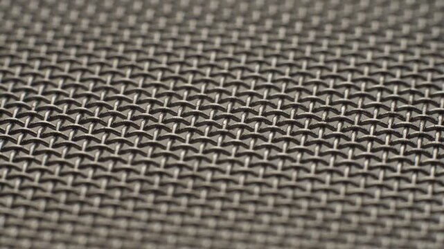 Metal wire mesh rotating in circle. Abstract background texture macro