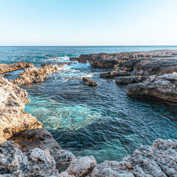 Crystal-clear cove nestled between sun-kissed rocks