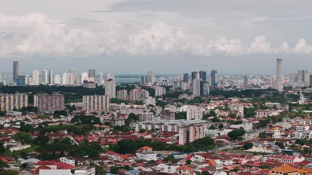 Georgetown cityscape revealing komtar tower rising above urban landscape with modern architectural development under overcast sky in penang, malaysia