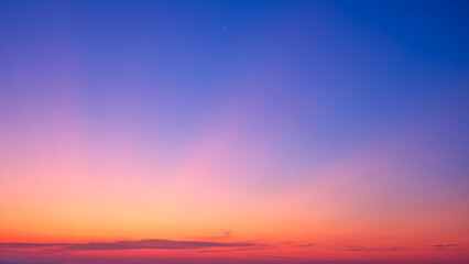 Twilight sky background with nature gradient light on colorful orange yellow and blue dusk sky after sundown