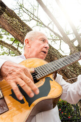 Colombian male artist playing an acoustic guitar in the town of Yaguara - Huila - Colombia....