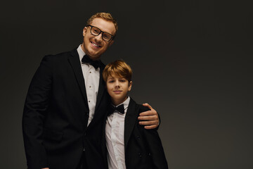 Father and son showcase elegance in stylish tuxedos during a studio session