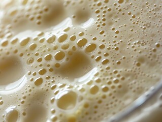 Detailed Close-up Macro of Creamy Vanilla Protein Shake with Condensation Droplets and Air Pockets on Surface