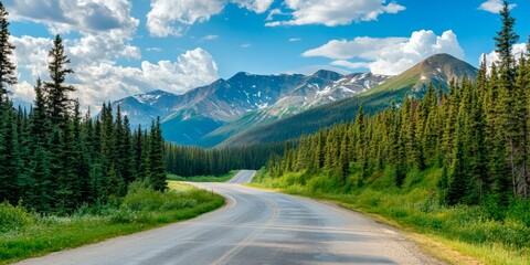 Scenic mountain road winds through a lush evergreen forest in the Canadian Rockies inspiring wanderlust and adventure.