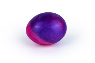 Vibrant single easter egg with   unique blend of purple and pink hues, isolated on white background. Color contrast, creativity, holiday decoration, symbolism of rebirth. Copy space. Selective focus
