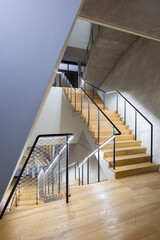Spiral Concrete Staircase with Wooden Handrail