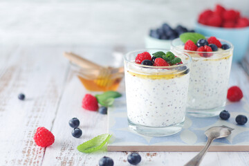 Greek yogurt in glasses with berries and quinoa