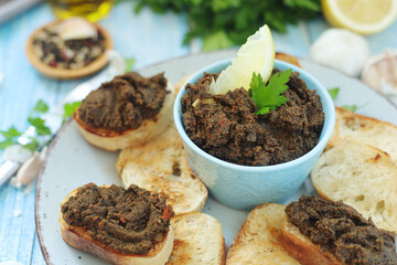 A bowl with tapenade - traditional olive dip in Mediterranean region