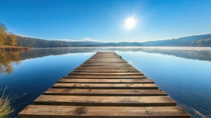 Fototapeta premium A wooden pier with sun-bleached planks extending into a tranquil lake, reflections on the water, peaceful scene