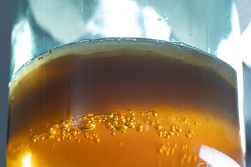 A close-up of the sparkling amber kombucha tea mushroom drink, beautifully displaying its bubbles...