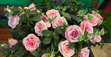 Arrangement of pink artificial roses. The roses are made from sofe pink cloth. Artificial flowers...