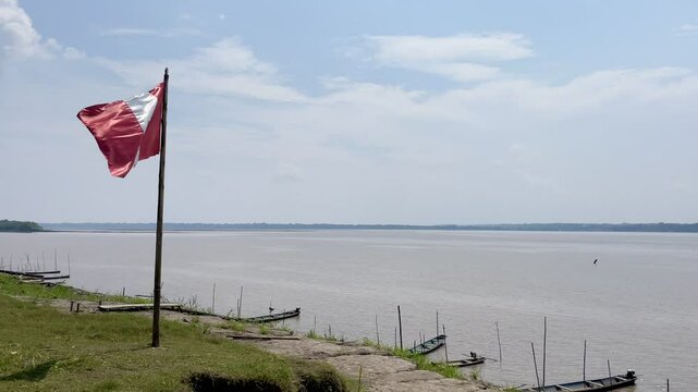 Peruvian flag on the banks of the Amazon, Island San Antonio de Cacao, Peru.