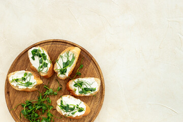 Toasts with with cream cheese and micro greens peas, healthy snack. Top view