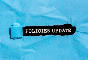 Policies update message written on ripped blue torn paper on black background. Conceptual policies...