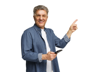 Cheerful older man holding smartphone and pointing while smiling against a plain background