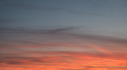 colorful soft sky background with sunset afterglow in red and gray