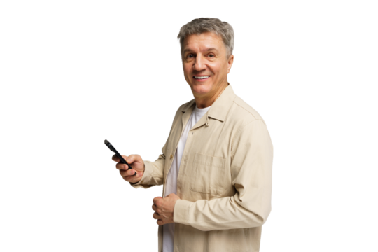 Smiling older man holding smartphone while dressed casually at home in bright atmosphere
