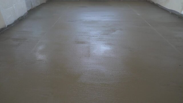 Concrete floor drying process showing the gradual changes in the material's appearance as it sets