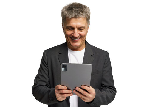 Middle-aged man smiles while using a tablet in a bright setting for work or leisure activities