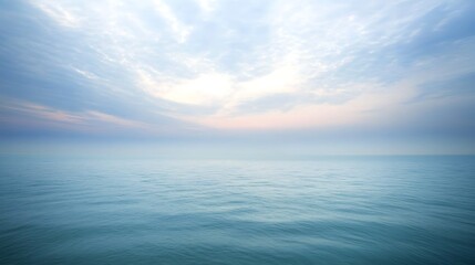 Obraz premium A soft pastel blue sky with clouds tinged in light lavender and pink shades, floating lazily across the calm expanse, evoking a sense of relaxation and calmness.