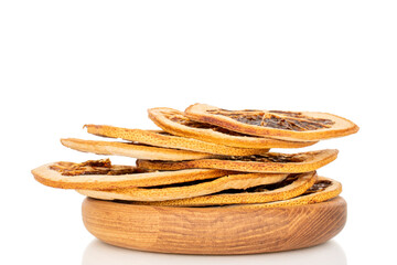 Obraz premium Several dried grapefruit slices on a wooden plate, close-up, isolated on a white background.