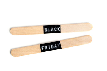 Black friday label on wooden sticks isolated on white background, top view.